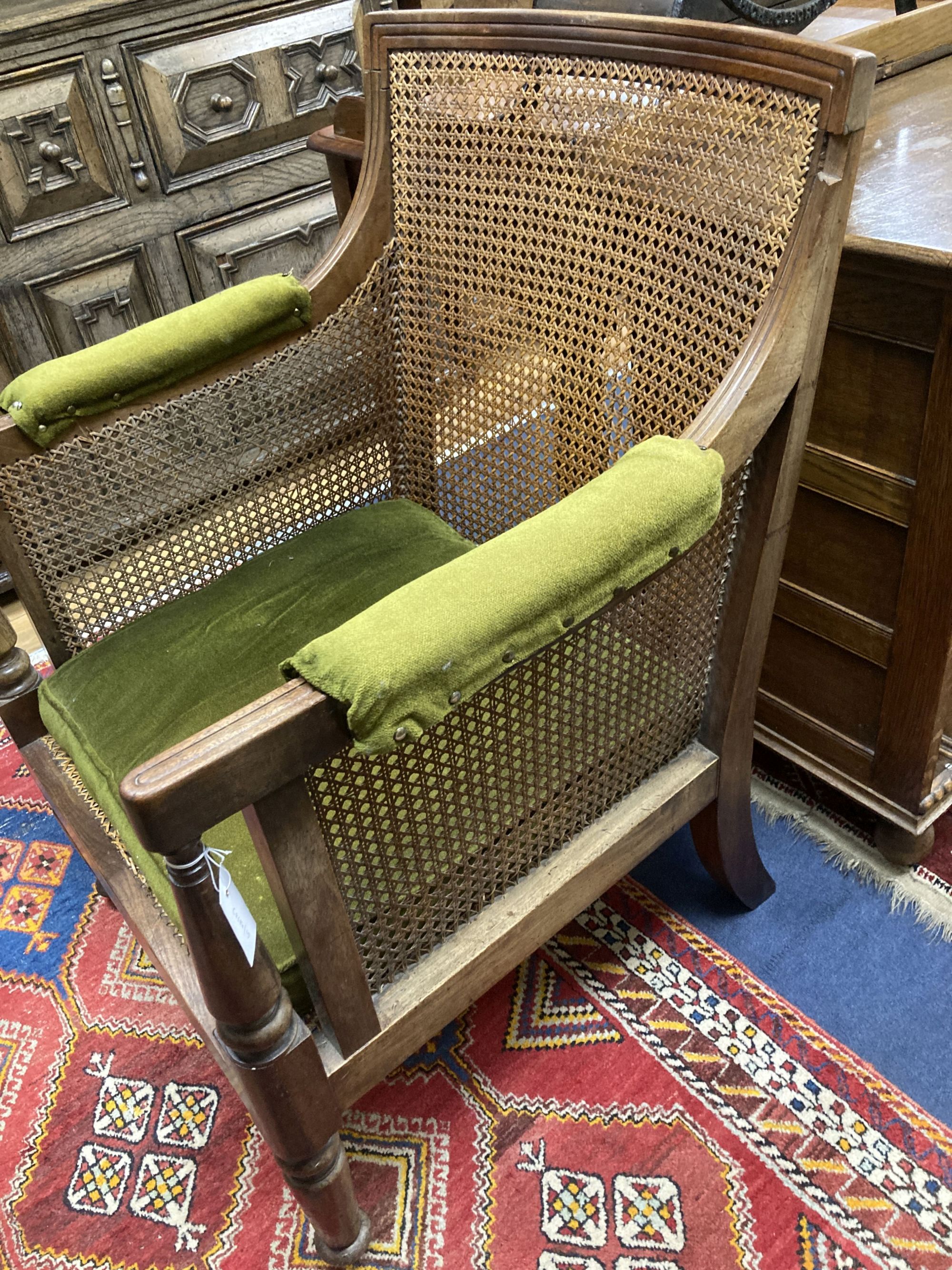 A Regency mahogany bergere armchair, width 67cm, depth 64cm, height 92cm